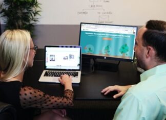 Using HubSpot for Effective Inbound Marketing Strategies man and woman sitting down in front of table