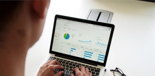 10 Must-Have Tools for New Startups: A Comprehensive Guide to Boost Growth person using MacBook Pro