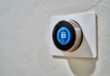 Technology Gadgets and Smart Home Devices for 2023 gray Nest thermostat displaying at 63