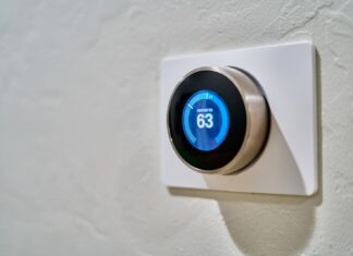 Technology Gadgets and Smart Home Devices for 2023 gray Nest thermostat displaying at 63