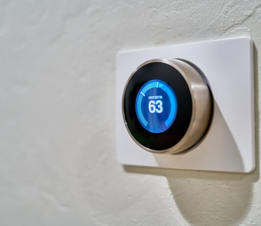 Technology Gadgets and Smart Home Devices for 2023 gray Nest thermostat displaying at 63