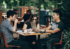 Why Are Millennials Embracing the Digital Currency Revolution? Young Millennials working and socializing in a vibrant cafe