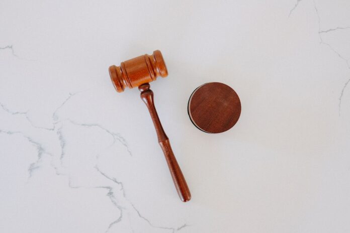 Photo by Tingey Injury Law Firm brown wooden smoking pipe on white surface