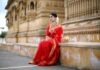 The Timeless Charm of Sarees: A Journey through Traditional Attire woman in red long sleeve dress sitting on gray concrete bench during daytime