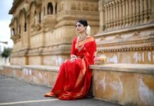 The Timeless Charm of Sarees: A Journey through Traditional Attire woman in red long sleeve dress sitting on gray concrete bench during daytime