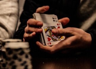 The Case for Playing Low-Stakes Poker person holding king of spade playing card