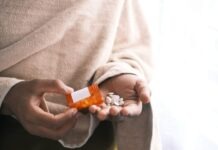 How Rehab Center Helps You Cope With Addiction orange and white plastic bottle on white textile