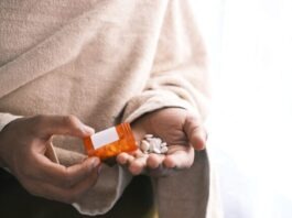 How Rehab Center Helps You Cope With Addiction orange and white plastic bottle on white textile