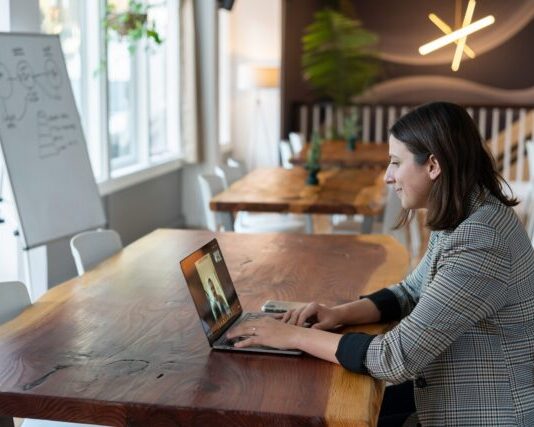 SAP CPQ: A Powerful Solution for Optimizing Sales woman in gray and white striped long sleeve shirt using silver macbook