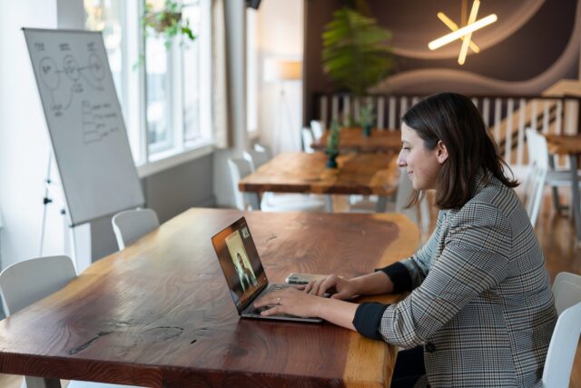 Photo by LinkedIn Sales Solutions woman in gray and white striped long sleeve shirt using silver macbook