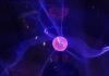 The Impact of Quantum Computing on Cosmos (ATOM) red ball with purple aura digital wallpaper