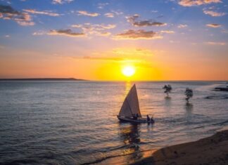 Bitcoin Trading System Impacts on the Businesses of Madagascar silhouette of people riding on sail boat on sea during sunset