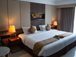 How to Make Your Hotel More Sustainable on a Budget white bed linen with throw pillows