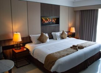 How to Make Your Hotel More Sustainable on a Budget white bed linen with throw pillows