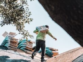 Choosing the Optimal Time of Year for Roof Replacement: Factors to Consider a man riding a skateboard on top of a roof