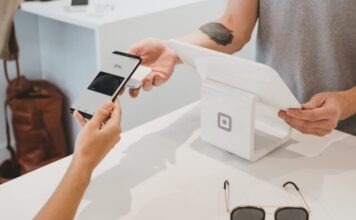 7 Ways Fintech is Using SMS person holding black Android smartphone close-up photography