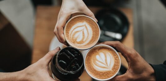 The Morning Ritual: Unlocking the Science of Coffee Preparation three person holding beverage cups