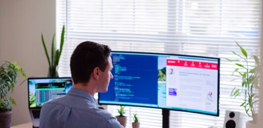Revving Up Innovation in the Automotive Industry with Idea Management Software man in gray dress shirt sitting on chair in front of computer monitor