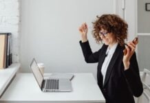 Fairness, Security, & Transparency: Ways Online Casinos Give These Options? A Woman in Black Blazer Sitting in Front of the Table with Laptop