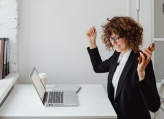 Fairness, Security, & Transparency: Ways Online Casinos Give These Options? A Woman in Black Blazer Sitting in Front of the Table with Laptop