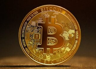 Crypto Arbitrage: Bitcoin Trading Across Exchanges a golden bitcoin sitting on top of a table
