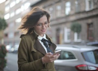 Exploring the Benefits of Mobile-Friendly Online Slot Sites Stylish adult female using smartphone on street