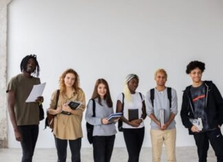 The Future of College Admissions: Trends and Challenges Group of diverse young multiracial classmates with notebooks and textbooks and backpacks smiling at camera