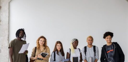 The Future of College Admissions: Trends and Challenges Group of diverse young multiracial classmates with notebooks and textbooks and backpacks smiling at camera