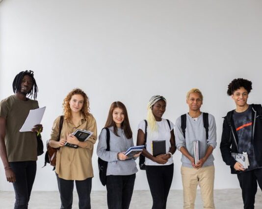 The Future of College Admissions: Trends and Challenges Group of diverse young multiracial classmates with notebooks and textbooks and backpacks smiling at camera