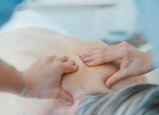 How Non-drug, Non-invasive Techniques are Revolutionizing Pain Management person massaging the back of a woman