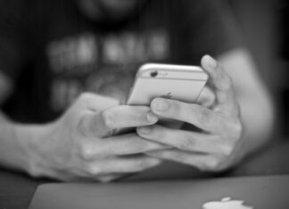 How to Make Your First Deposit in an Online Casino person holding iPhone