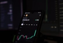 Bitcoin Wallets: Safeguarding Against Risks a cell phone displaying a stock chart on the screen