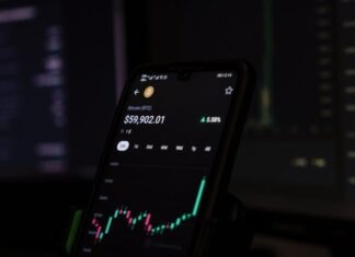 Bitcoin Wallets: Safeguarding Against Risks a cell phone displaying a stock chart on the screen