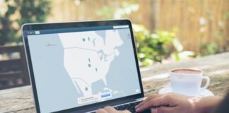 How to Set Up and Use a VPN for Beginners Person Using Black and Gray Laptop Computer Beside White Ceramic Cup on Brown Wooden Table