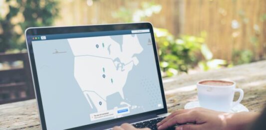 How to Set Up and Use a VPN for Beginners Person Using Black and Gray Laptop Computer Beside White Ceramic Cup on Brown Wooden Table