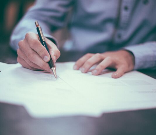 Gaining Confidence and Support: The Importance of Hiring a Family Lawyer man writing on paper
