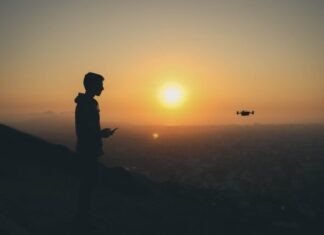 Balancing Work and Play: Essential Tech Hobbies for Men in the Business World silhouette photo of man holding drone remote