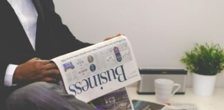 Independent Businessman or Oligarch? person sitting near table holding newspaper