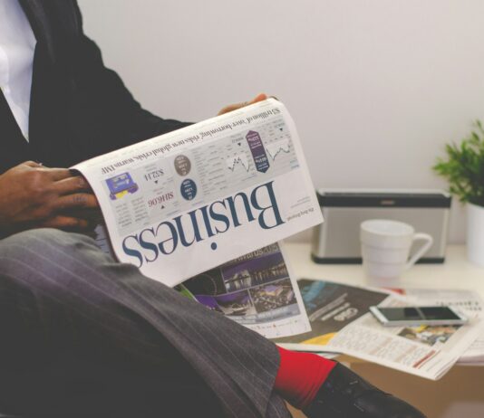Independent Businessman or Oligarch? person sitting near table holding newspaper