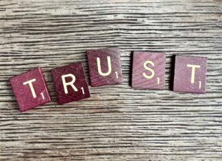 Common Misconceptions About Trusts and How to Address Them trust spelled with wooden letter blocks on a table
