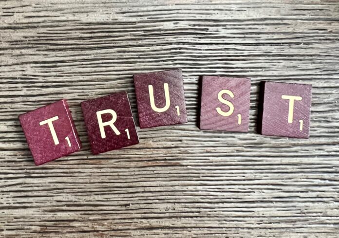 Photo by Ronda Dorsey trust spelled with wooden letter blocks on a table