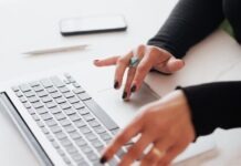 Discover the World of 918Kiss Gaming: An Introspective Journey Crop female using touchpad on laptop in office