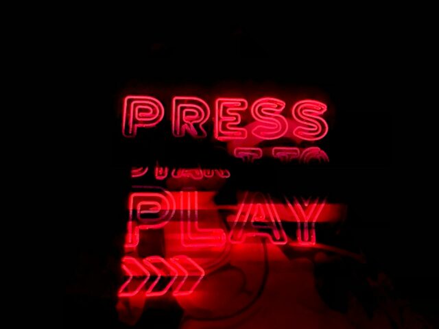 Photo by Anwar Hakim red Press Play neon sign