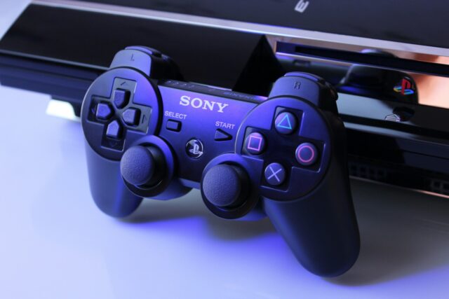 Photo by Nikita Kostrykin black Sony PS2 controller on white surface