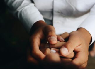 What To Expect From a Career in Public Health a close-up of hands holding coins