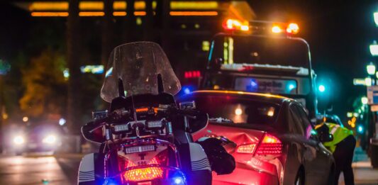 Understanding the Legal Process for Filing a Car Accident Claim in Chicago a motorcycle and a car on a street at night