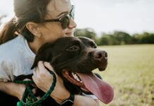 Tips for Balancing Being a College Student and Pet Parent woman hugging a dog