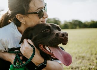 Tips for Balancing Being a College Student and Pet Parent woman hugging a dog