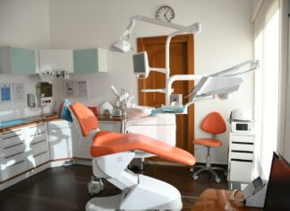 Should You Lease or Buy Your Dental Office Space? red and white massage chair