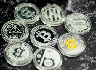 How to Choose the Right Bitcoin Miner Hosting Plan a pile of bitcoins sitting on top of a table